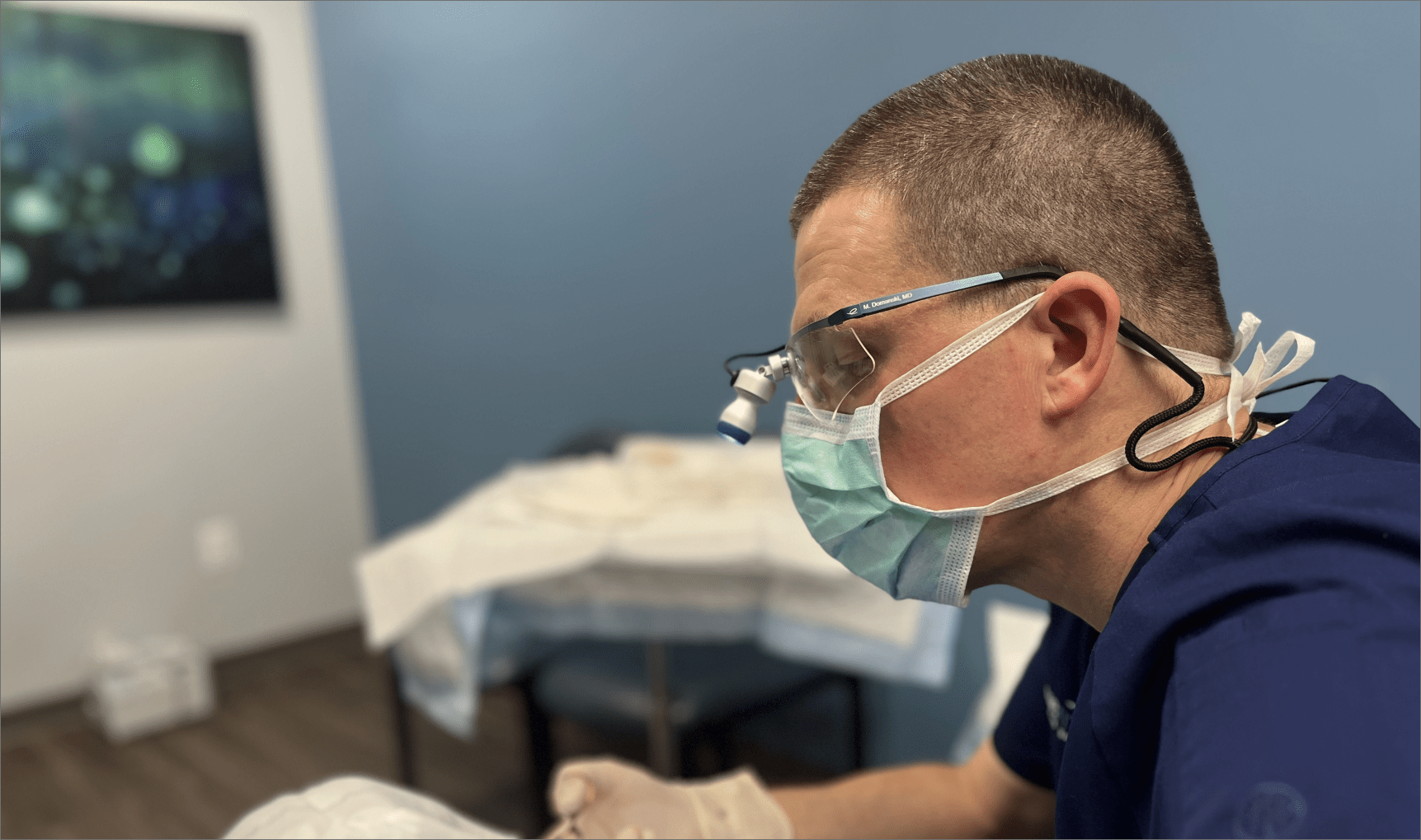 Dr. Mark Domanski, plastic surgeon in Fairfax, Northern VA, during an in-office plastic surgery procedure on a patient.