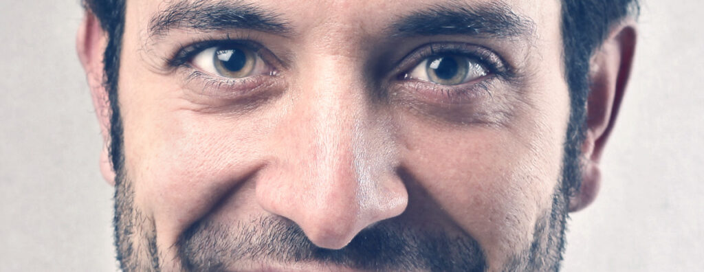 A close up of a young men looking for options to fix crooked nose