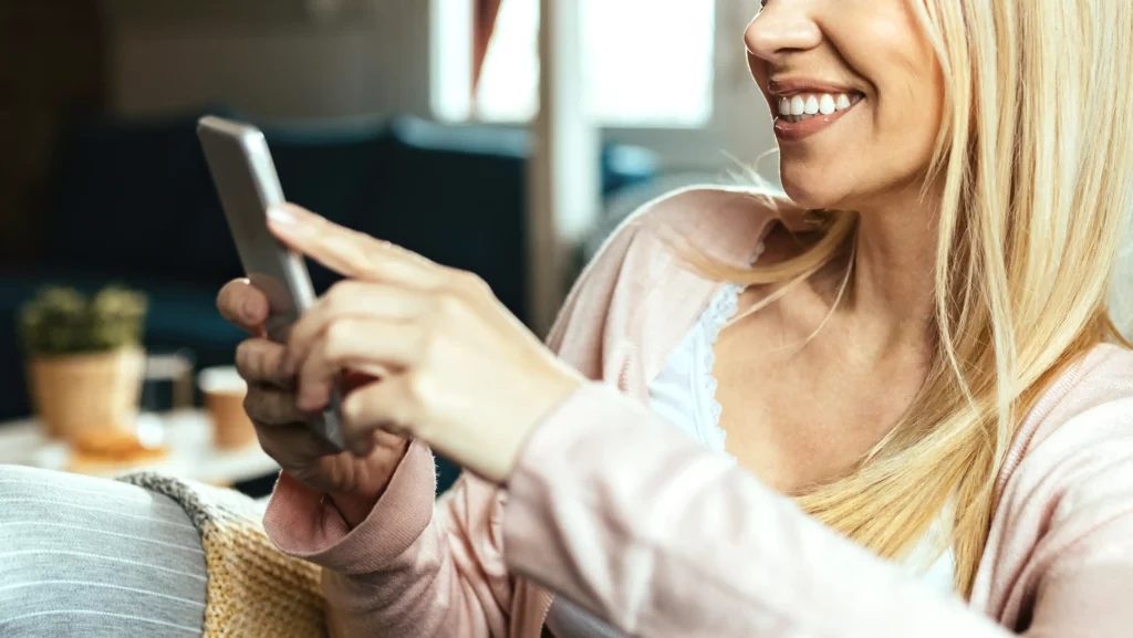 A women viewing plastic surgery social media posts on her phone